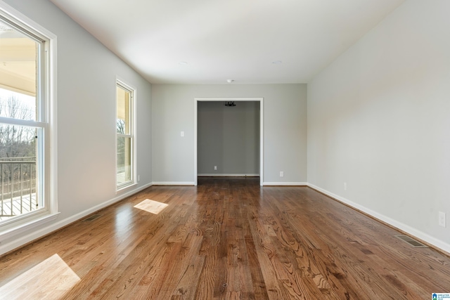 unfurnished room with wood-type flooring