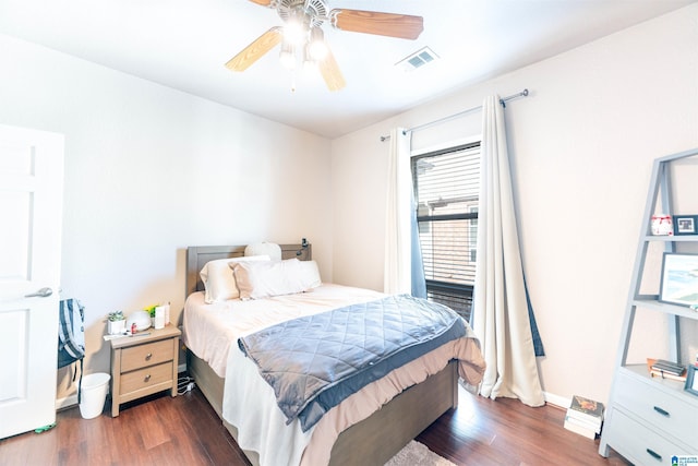 bedroom with ceiling fan and dark hardwood / wood-style floors