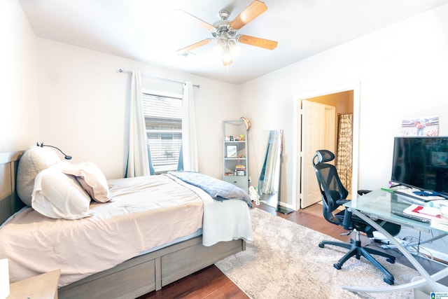 bedroom with dark wood-type flooring and ceiling fan