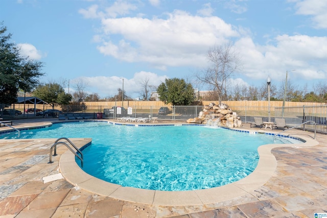 view of pool with a patio and pool water feature