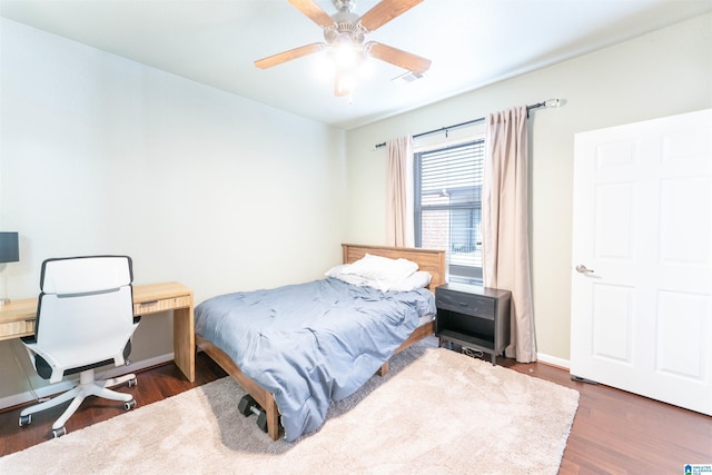 bedroom with dark wood-type flooring and ceiling fan