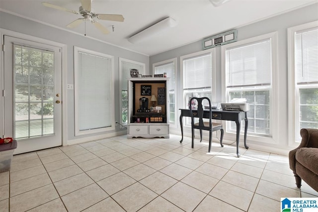 interior space featuring ceiling fan, a healthy amount of sunlight, light tile patterned floors, and crown molding