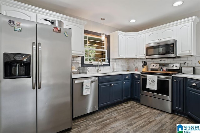 kitchen with blue cabinetry, white cabinetry, sink, and stainless steel appliances