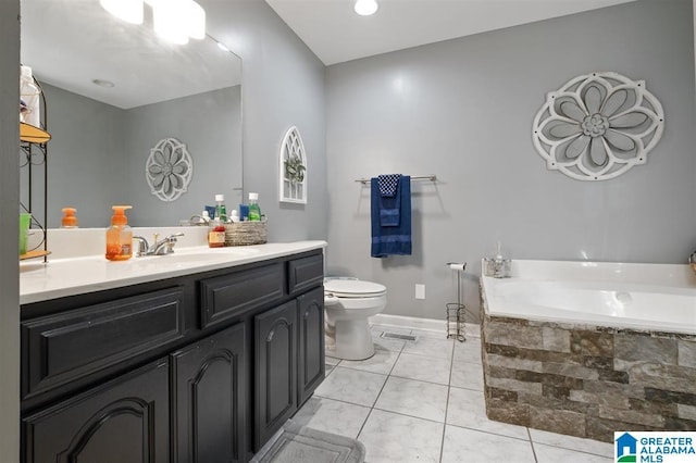 bathroom with tile patterned floors, a tub, vanity, and toilet