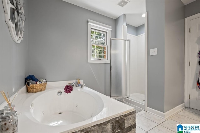 bathroom featuring tile patterned floors and independent shower and bath