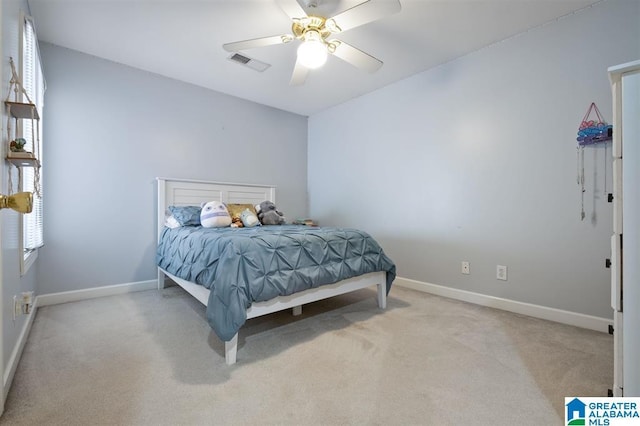 bedroom featuring ceiling fan and light carpet