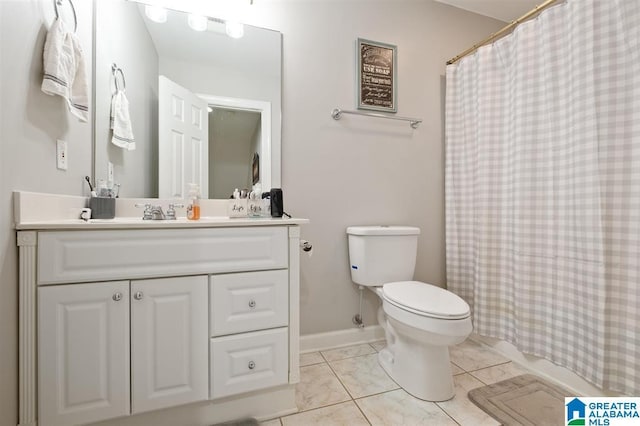 bathroom featuring tile patterned flooring, vanity, and toilet