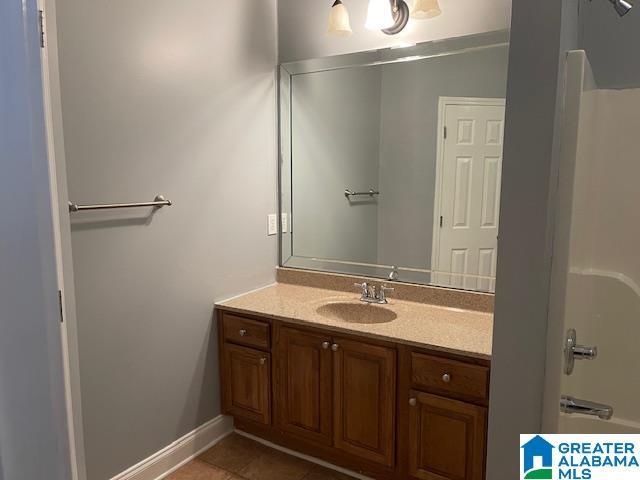 bathroom with vanity, tile patterned flooring, and shower / bathing tub combination