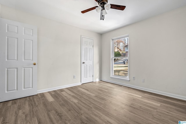 interior space with wood-type flooring and ceiling fan