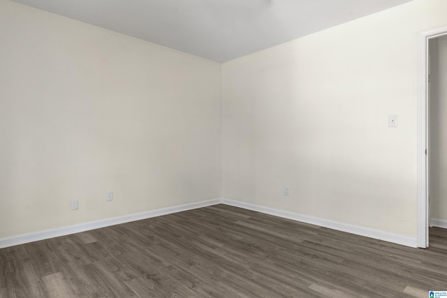 unfurnished room featuring dark hardwood / wood-style flooring