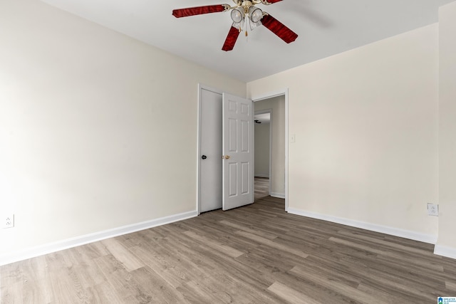 empty room featuring ceiling fan and wood-type flooring