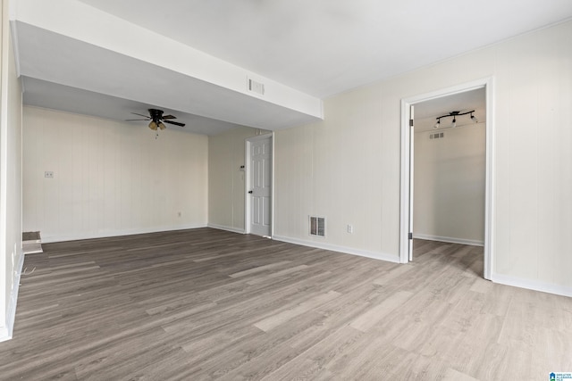 spare room with light wood-type flooring and ceiling fan