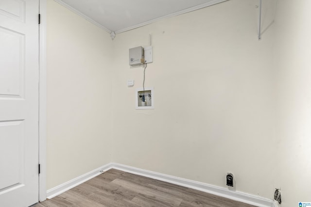 laundry area with hookup for a washing machine, hardwood / wood-style floors, and ornamental molding