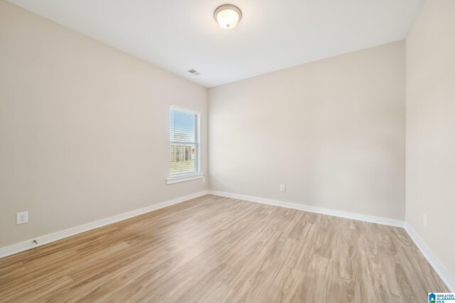 unfurnished room with light wood-type flooring