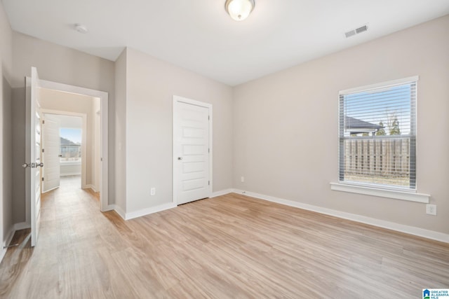 unfurnished bedroom featuring a closet and light hardwood / wood-style flooring