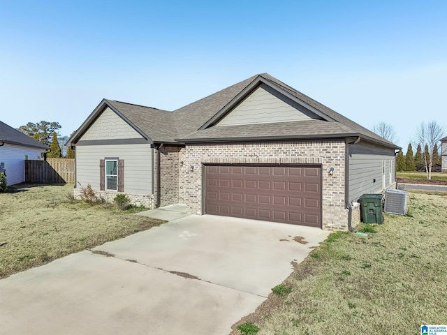 ranch-style home with central AC, a front yard, and a garage