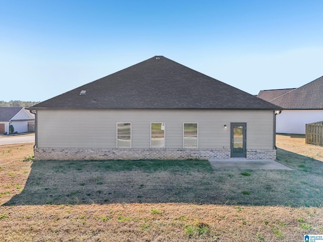 rear view of house with a patio area and a yard