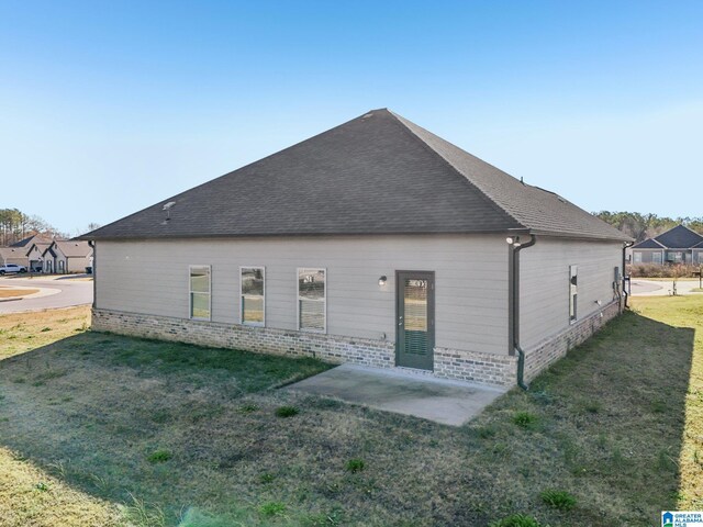 rear view of property featuring a lawn