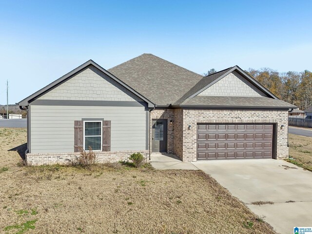 view of front facade with a garage and a front lawn