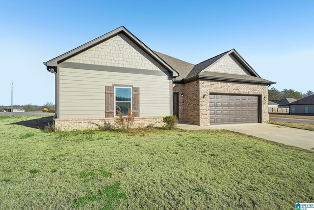 view of front of house with a garage and a front lawn