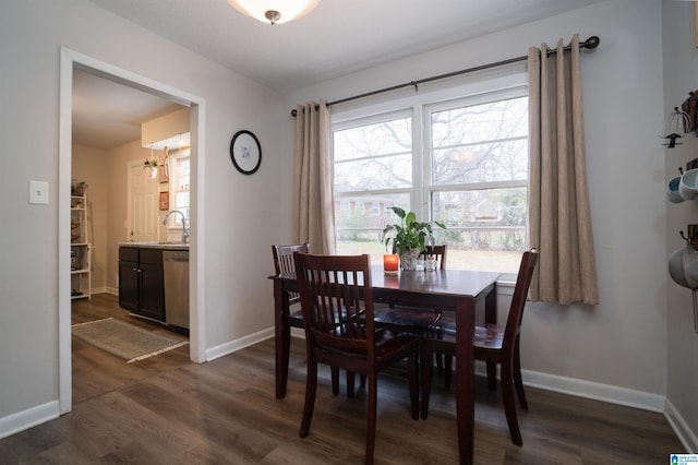 dining area featuring a healthy amount of sunlight, dark hardwood / wood-style flooring, and sink