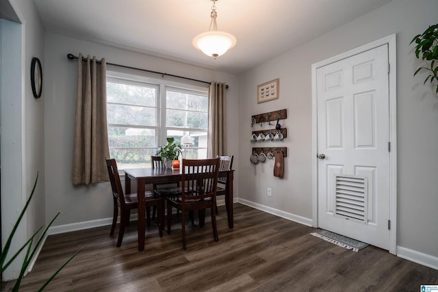 dining space with dark wood-type flooring