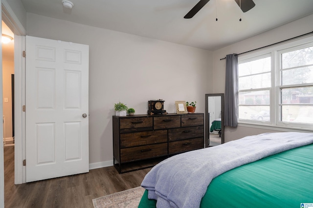 bedroom with dark hardwood / wood-style floors and ceiling fan