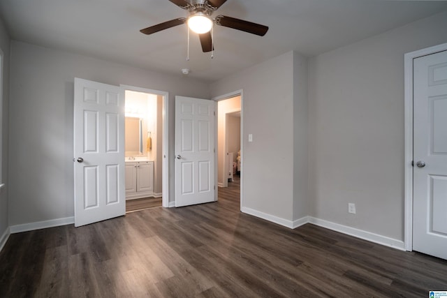 unfurnished bedroom featuring ceiling fan, dark wood-type flooring, and ensuite bath