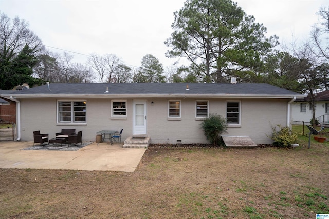 back of house with a patio area and a lawn