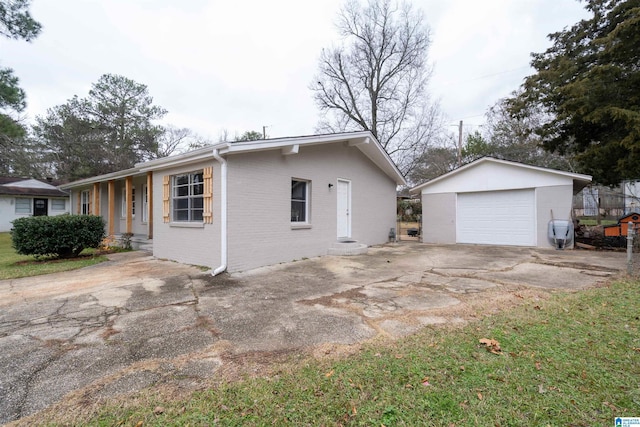 view of property exterior with covered porch, an outdoor structure, and a garage