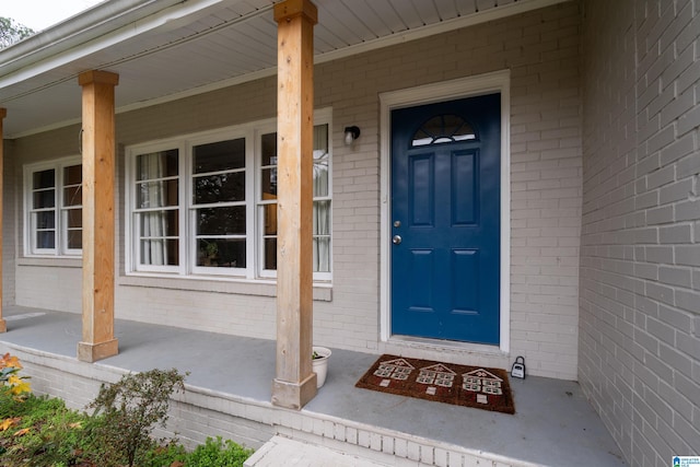 view of exterior entry with covered porch