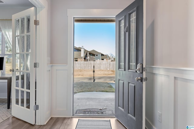 foyer entrance with a wealth of natural light and hardwood / wood-style floors