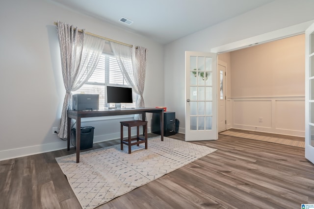 office with french doors and hardwood / wood-style flooring