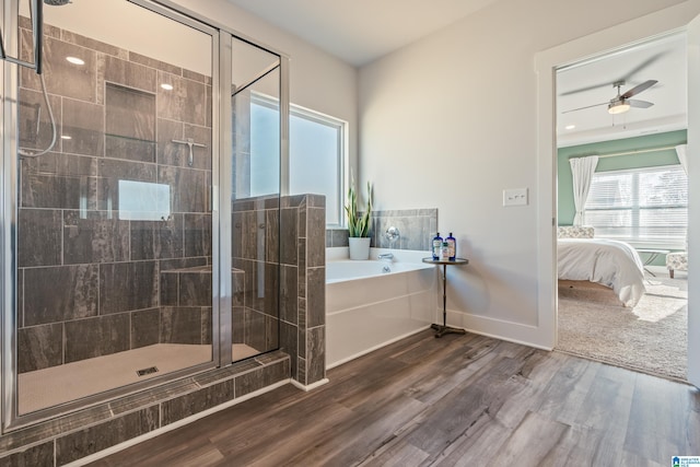 bathroom featuring ceiling fan, wood-type flooring, and shower with separate bathtub