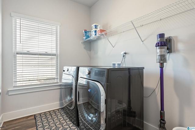 clothes washing area with hardwood / wood-style floors, separate washer and dryer, and plenty of natural light