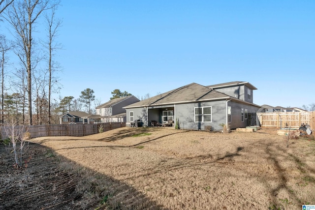 rear view of house with a yard