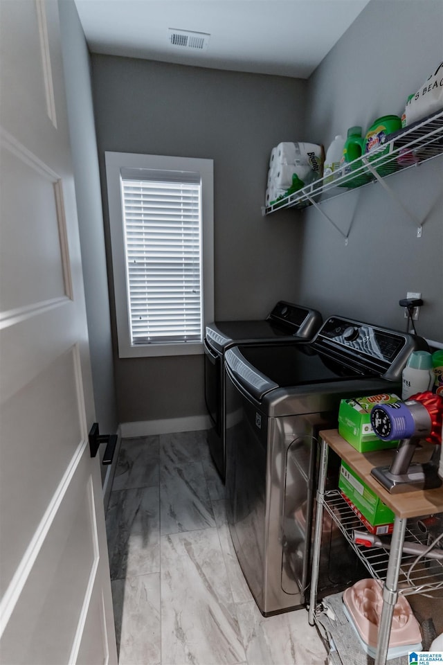 clothes washing area with washing machine and clothes dryer