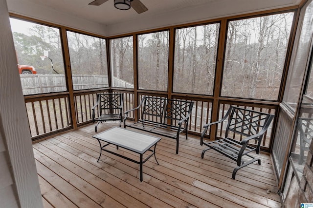 unfurnished sunroom with ceiling fan