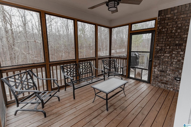 sunroom / solarium featuring ceiling fan