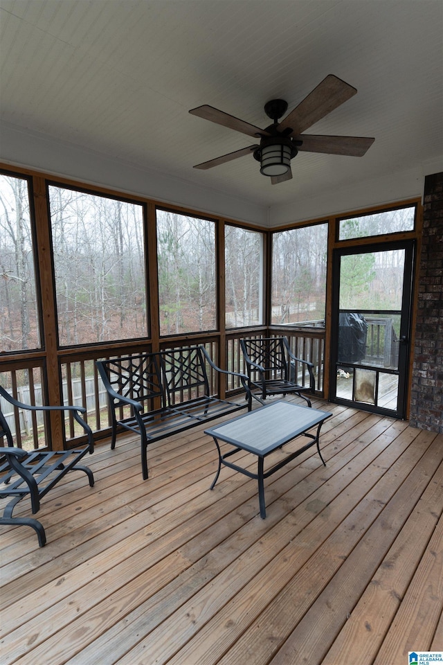 unfurnished sunroom featuring ceiling fan