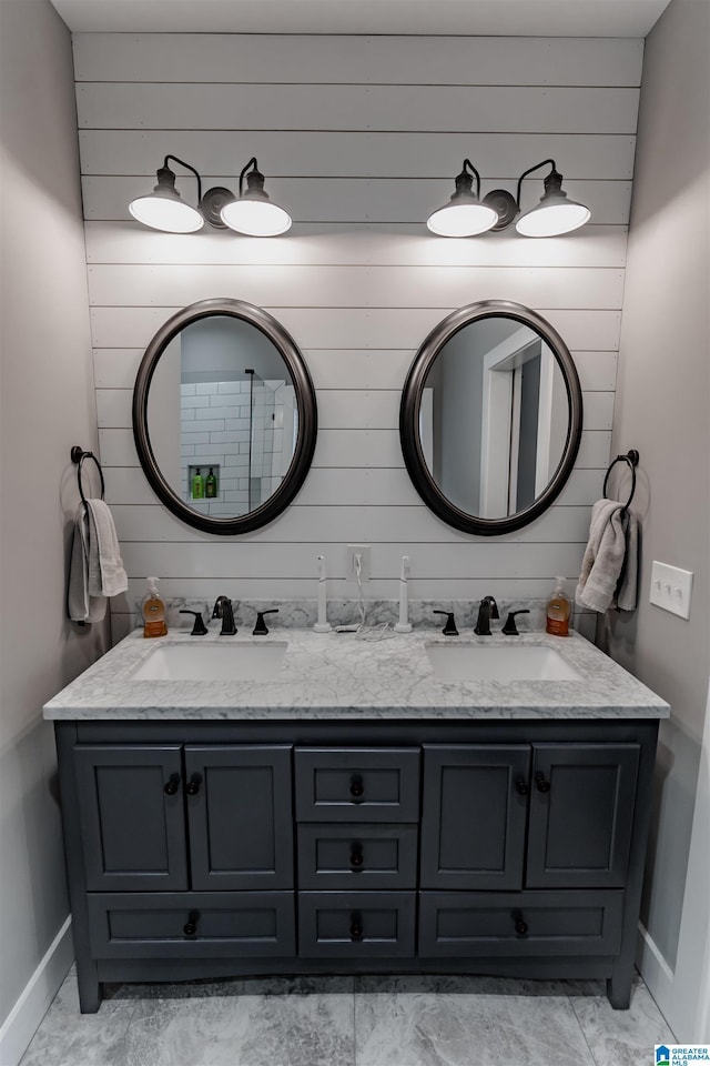 bathroom with vanity and wood walls