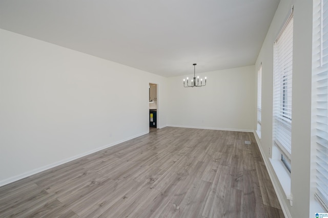 interior space with a chandelier and light hardwood / wood-style floors