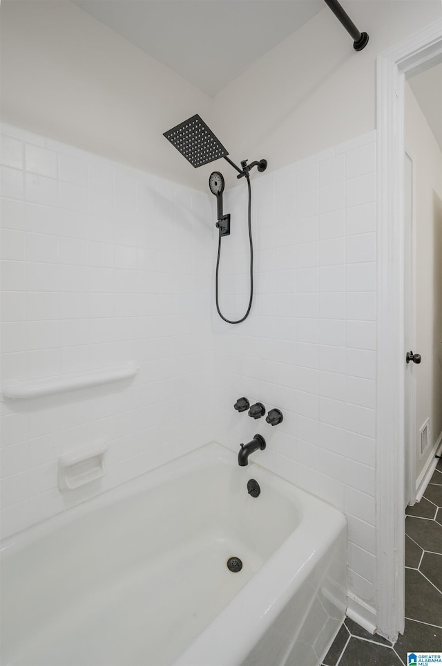 bathroom featuring tile patterned flooring and tiled shower / bath combo