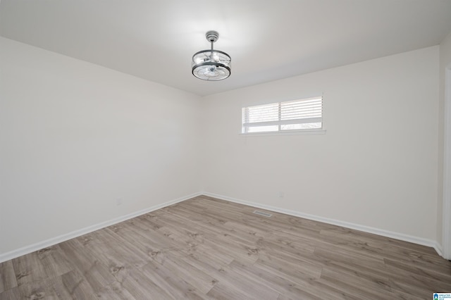 unfurnished room with light hardwood / wood-style floors