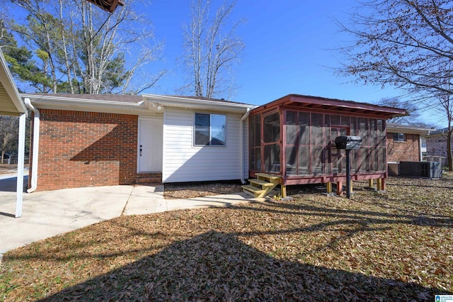 back of house featuring cooling unit and a sunroom