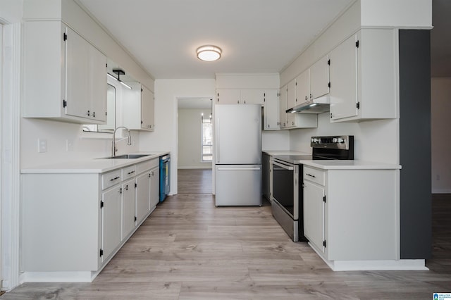 kitchen with appliances with stainless steel finishes, light hardwood / wood-style floors, white cabinets, and sink