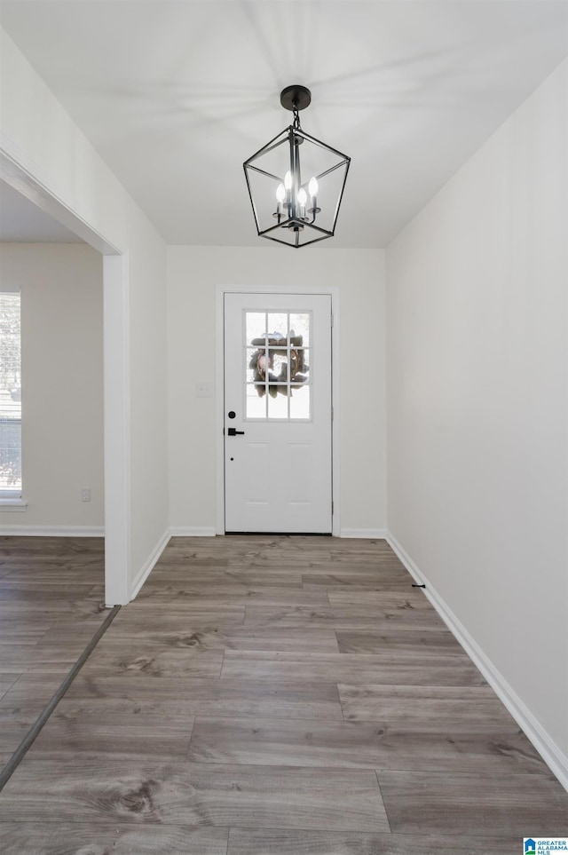 doorway to outside featuring a chandelier and hardwood / wood-style flooring