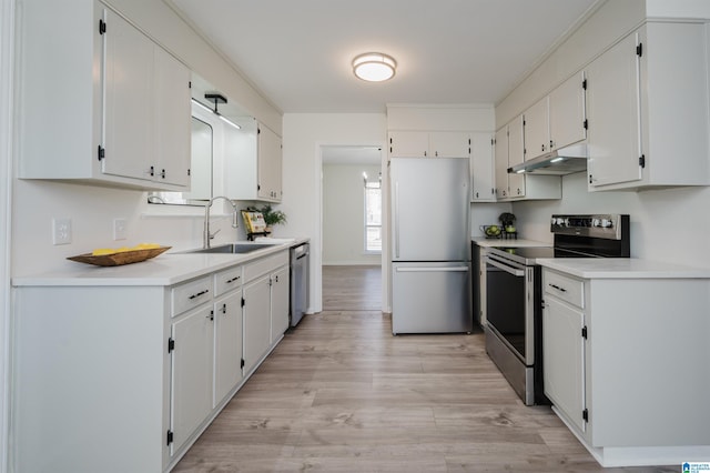 kitchen with light hardwood / wood-style floors, sink, white cabinets, and stainless steel appliances