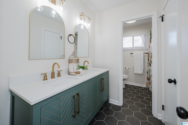 bathroom featuring toilet, vanity, and tile patterned flooring