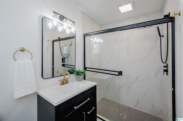 bathroom featuring vanity and a shower with door